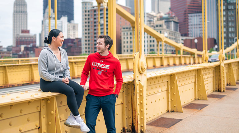 Two Duquesne University students on the Rachel Carson Bridge in Pittsburgh
