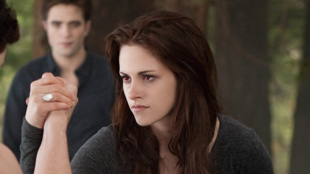 Still image of Kristen Stewart as Bella Swan from Breaking Dawn Part 2, showcasing her vampire transformation with red eyes and pale skin.