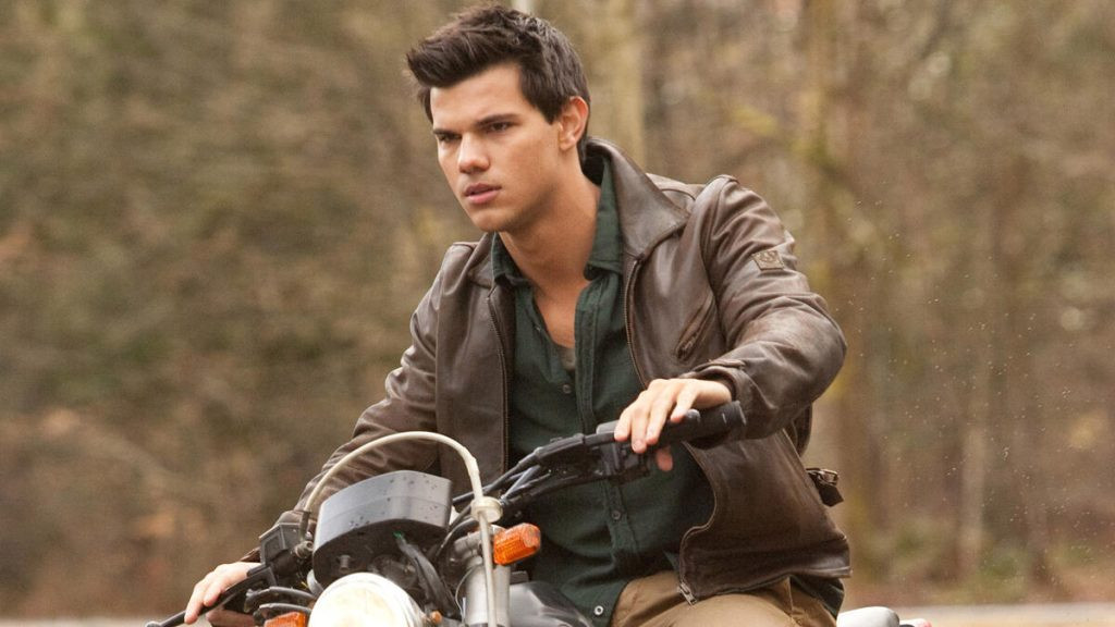 Still of Taylor Lautner as Jacob Black in Breaking Dawn Part 1, showing his werewolf physique and tribal tattoo.