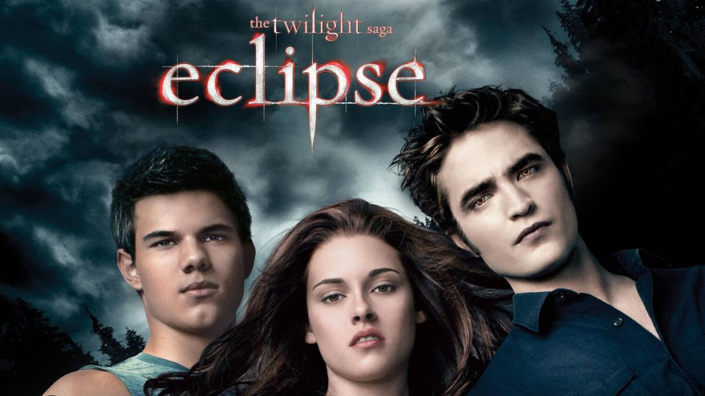 Promotional image for The Twilight Saga: Eclipse, depicting Bella Swan standing between Edward Cullen and Jacob Black in a snowy forest, emphasizing the love triangle.