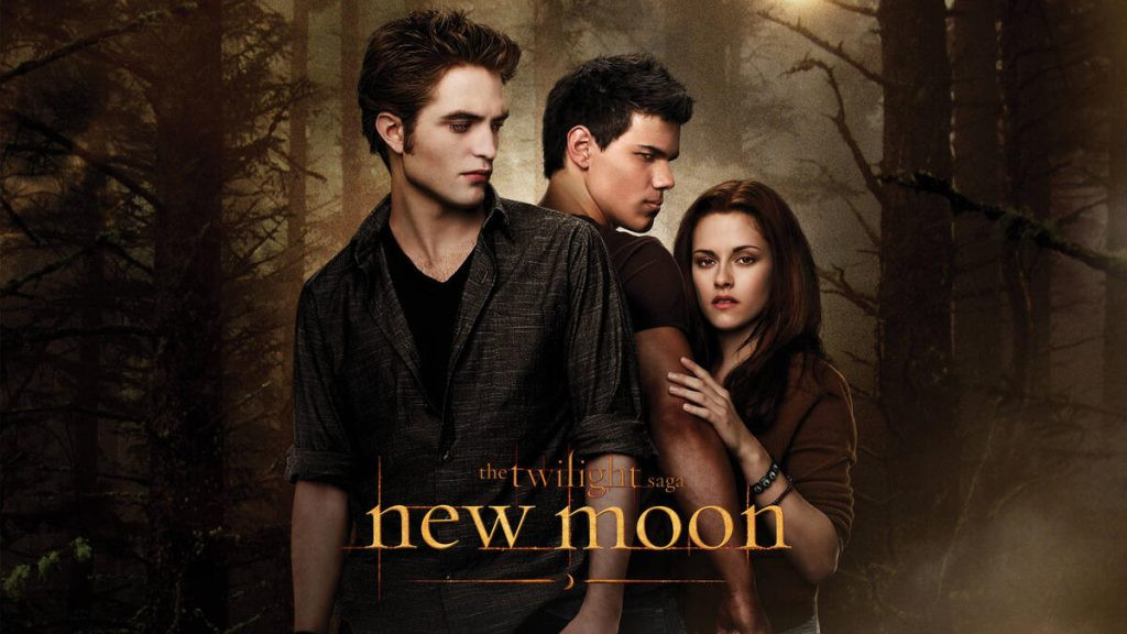 Movie poster for The Twilight Saga: New Moon, showcasing Bella Swan looking forlornly into a forest, with Jacob Black and Edward Cullen visible in the background.