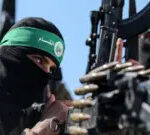 Getty Images Hamas fighters wearing balaclavas hold weapons