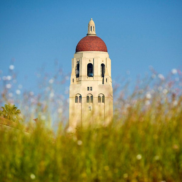 Exterior view of Hoover Tower at Stanford University under a sunny sky.
