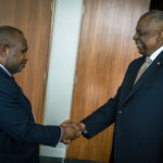 U.S. Secretary of Defense Lloyd J. Austin III greets Papua New Guinean Prime Minister James Marape, highlighting the importance of leader meetings in international relations.