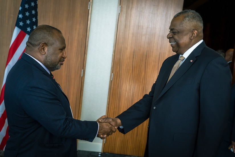 U.S. Secretary of Defense Lloyd J. Austin III greets Papua New Guinean Prime Minister James Marape, highlighting the importance of leader meetings in international relations.