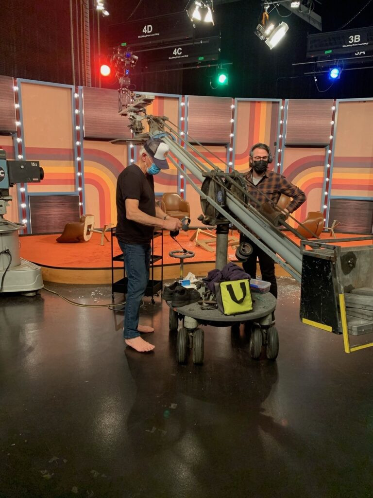 Key grip Tony Hall and 2nd AC Matt Wilson with the period correct crane used in Late Night with the Devil