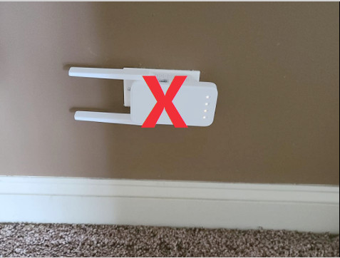 Example of incorrect WiFi extender placement, likely obstructed or poorly positioned
