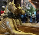 Stephen Greaves/BBC News A massive golden Great Dane sculpture is seen in the lobby of The Ben hotel