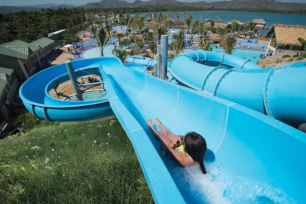 Aqua Zone pool area at Amber Cove with waterslides and swim-up bar