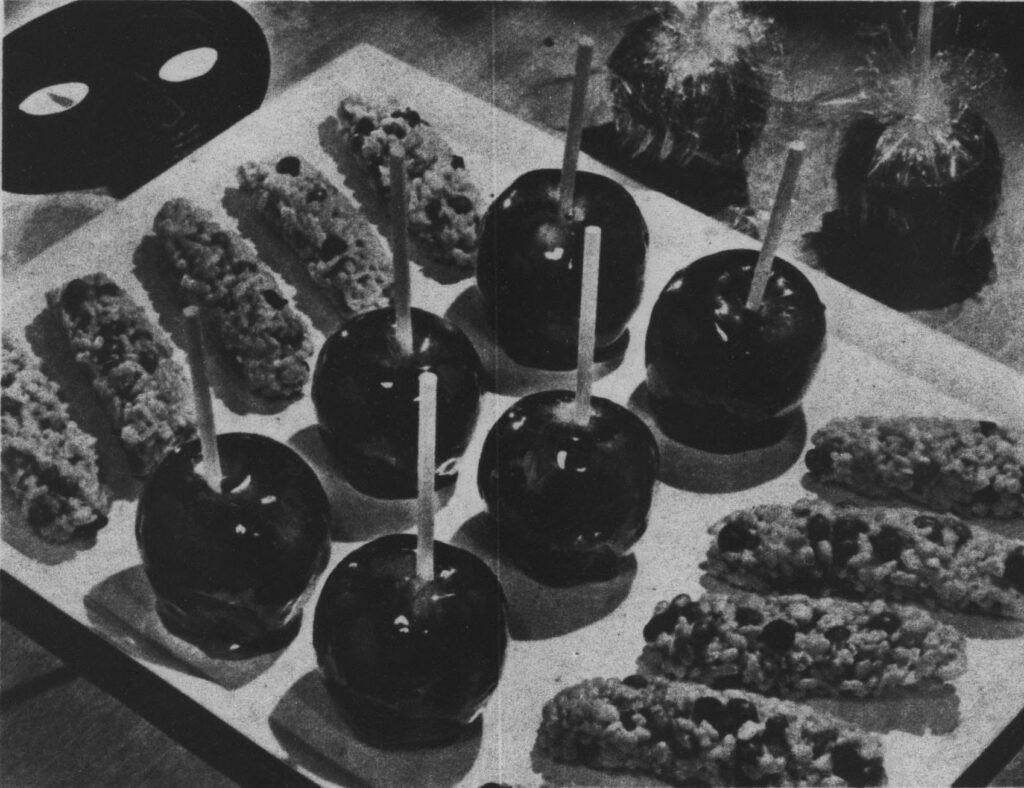 Image detail from a 1956 newspaper showing candy apples, illustrating the evolution of Halloween treats to include candied fruits.