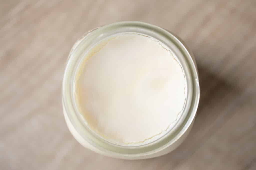 Overhead view of chilled beef tallow in a glass mason jar.