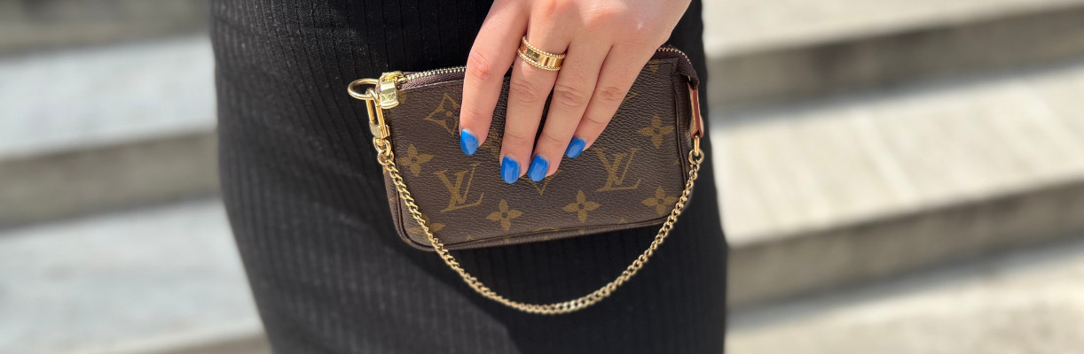 Close-up of a mini Louis Vuitton handbag showcasing its iconic monogram canvas and leather details