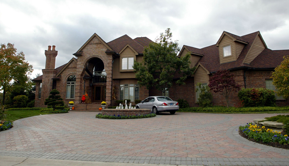 Close-up of Eminem's large brick house with multiple rooflines in Michigan