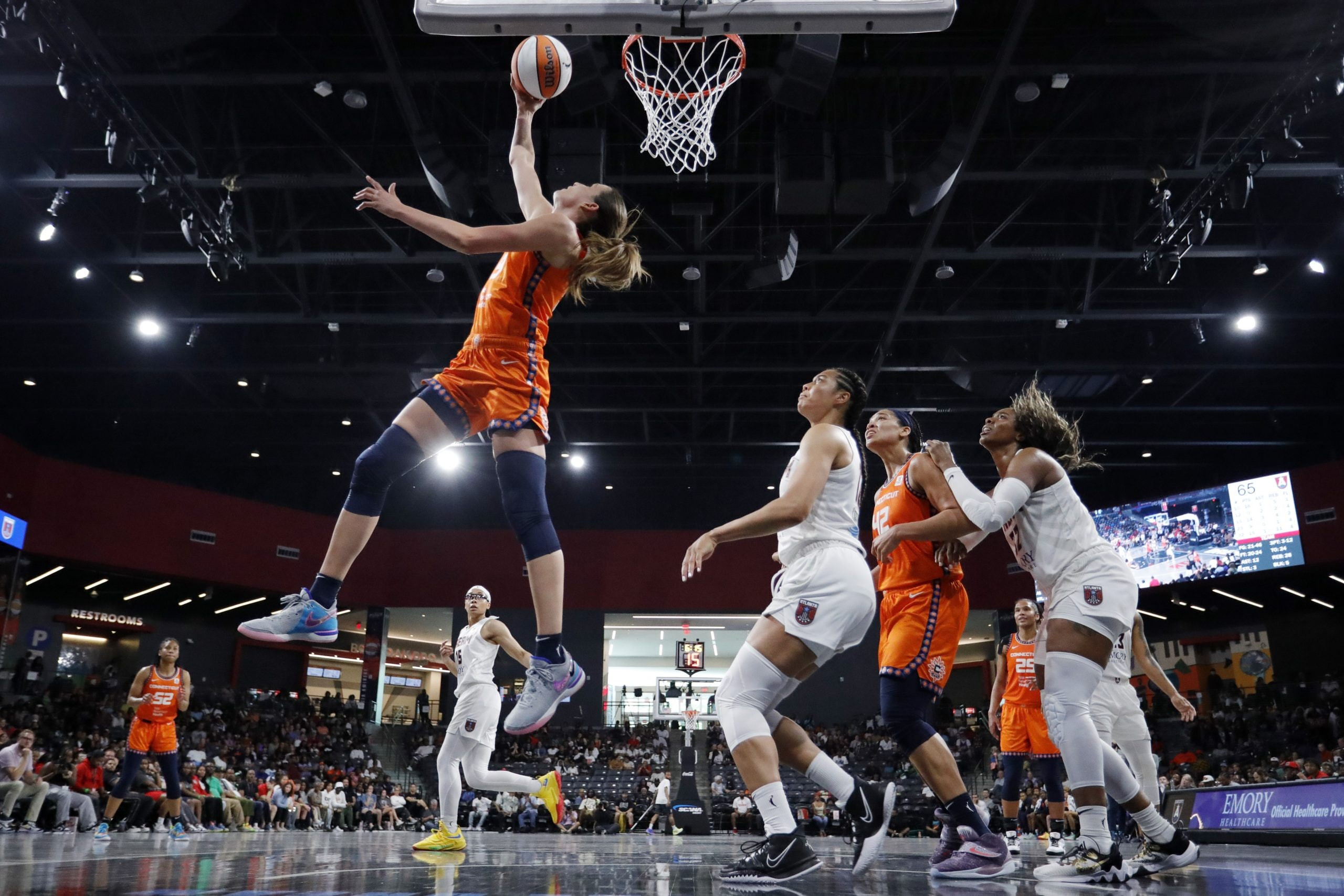 Dynamic action shot from a Connecticut Sun vs. Atlanta Dream WNBA game, highlighting the intensity and athleticism of women's professional basketball.