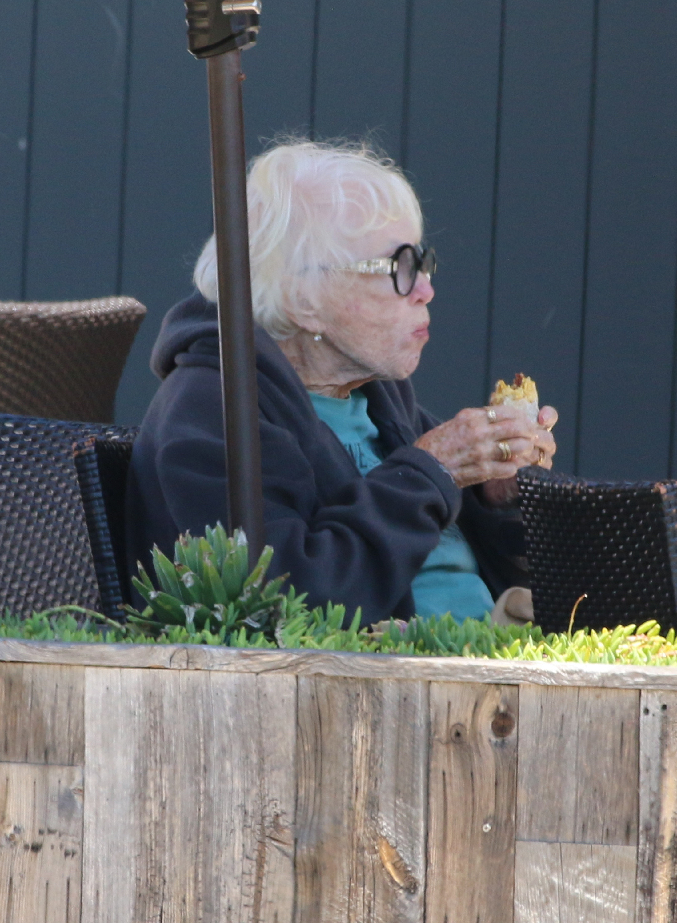 Shirley MacLaine enjoying a sunny lunch in Malibu, dressed in a stylish blue jacket and black pants