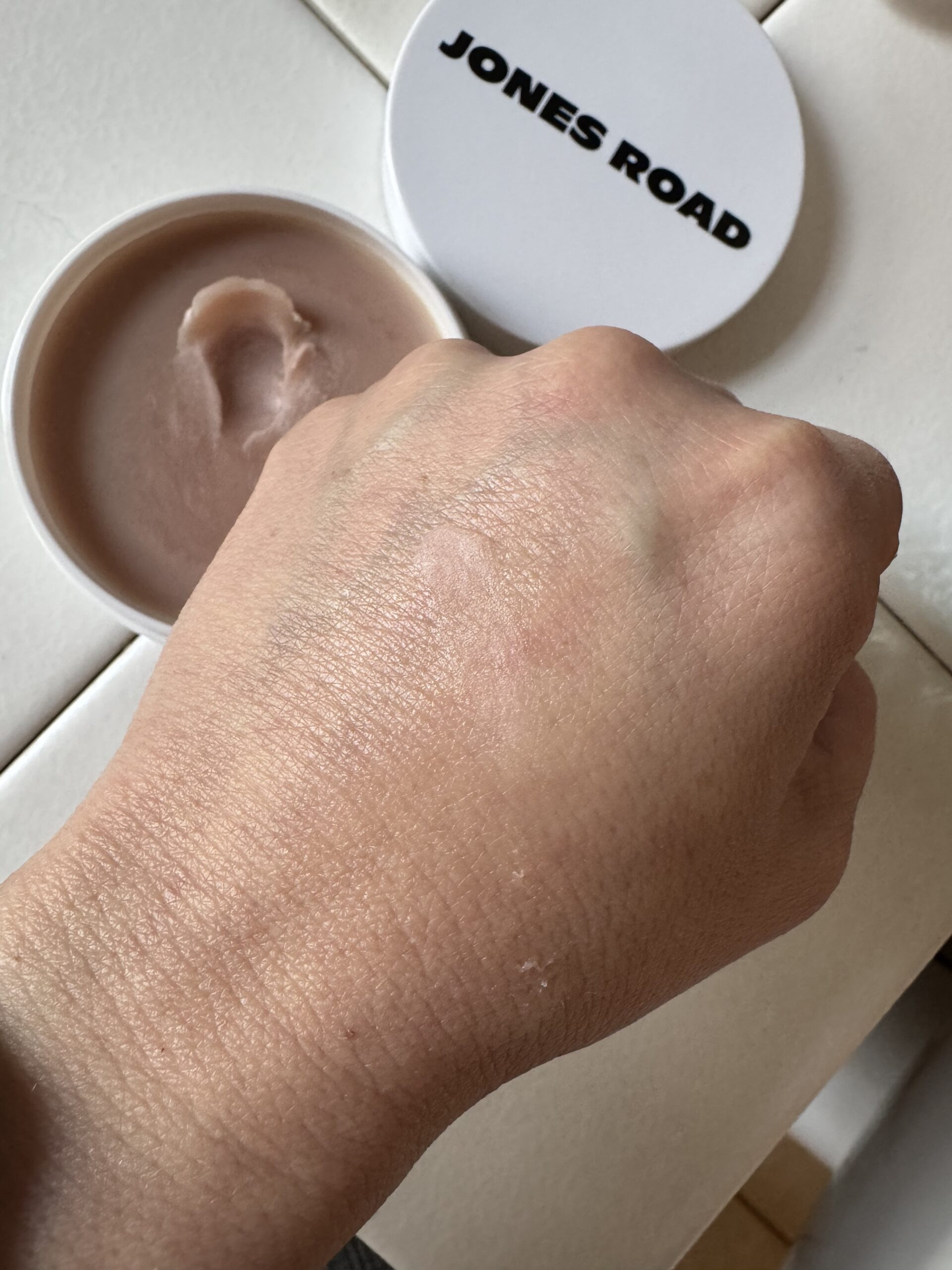 Hand with Miracle Balm in Au Natural application