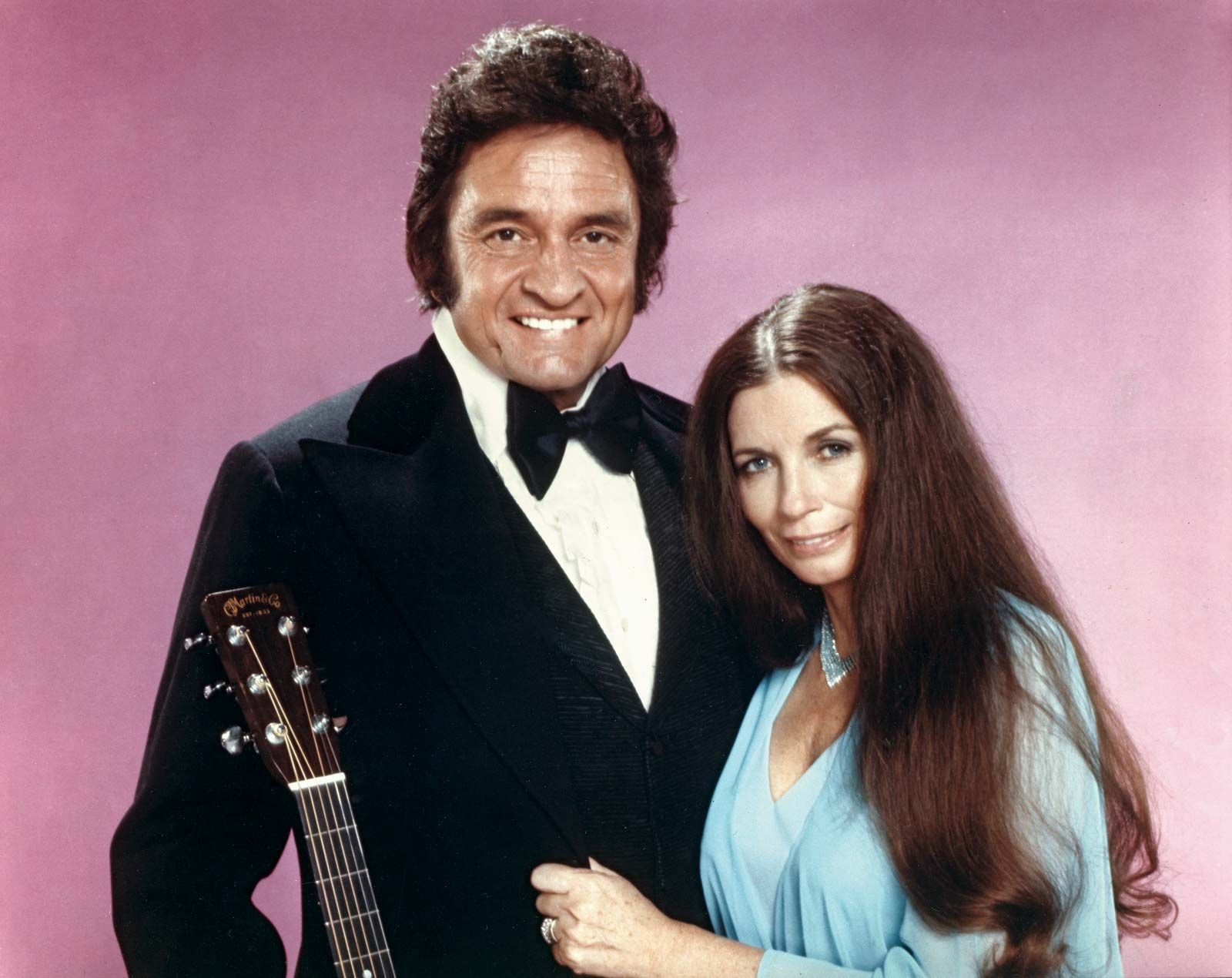 Johnny Cash and June Carter Cash, a legendary couple in country music, showcasing their love and musical partnership.