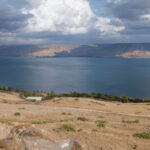 View of Sea of Galilee, Israel, showcasing the serene waters and surrounding hills, reflecting the geographical context of early Christianity.