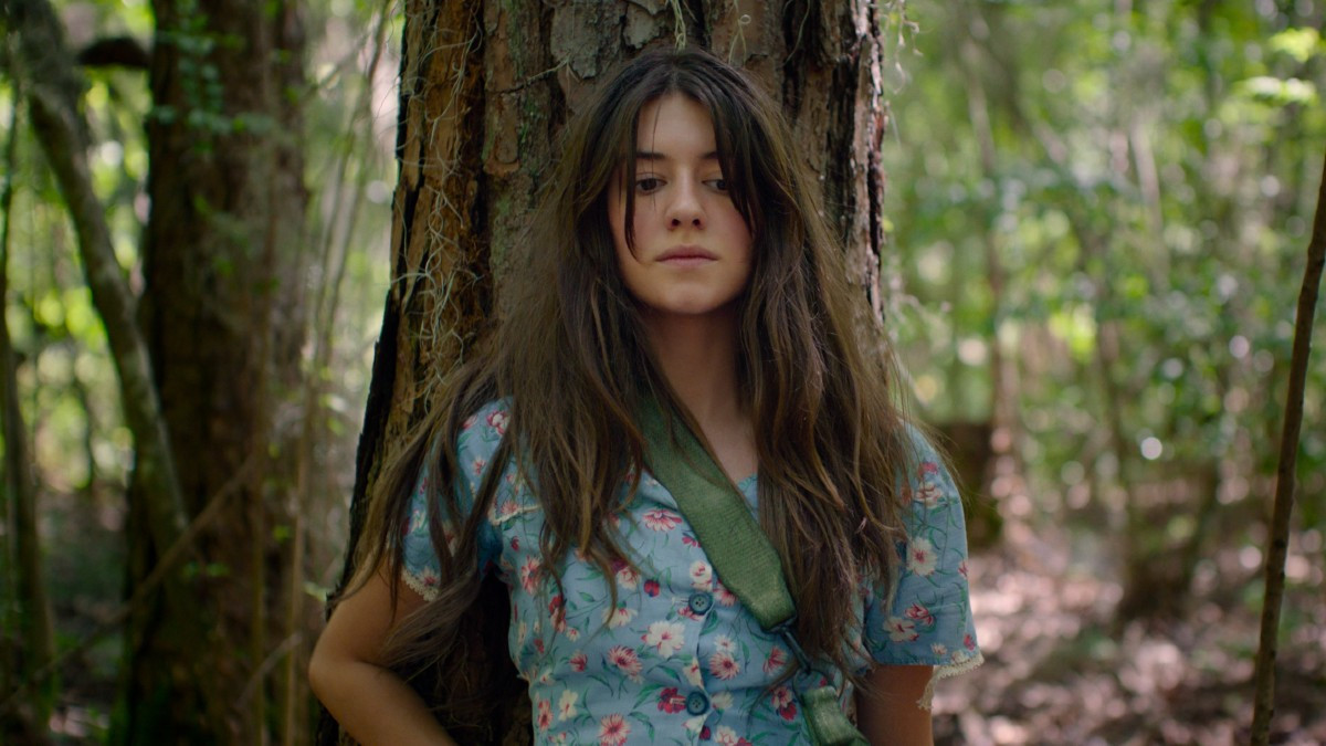 Daisy Edgar-Jones as Kya in Where the Crawdads Sing film, looking thoughtfully into the marsh.