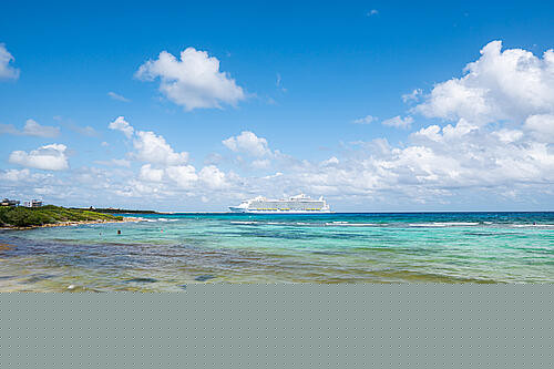 Tourists enjoying the beach and clear waters in Roatan, Honduras, showcasing a vibrant and cost-effective port excursion