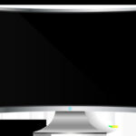 Close up of a hand pressing the power button on a Dell computer monitor.