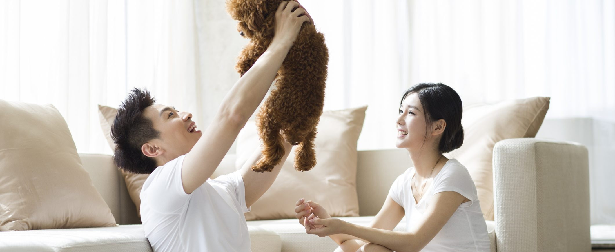 A couple spending time in their living room with their dog