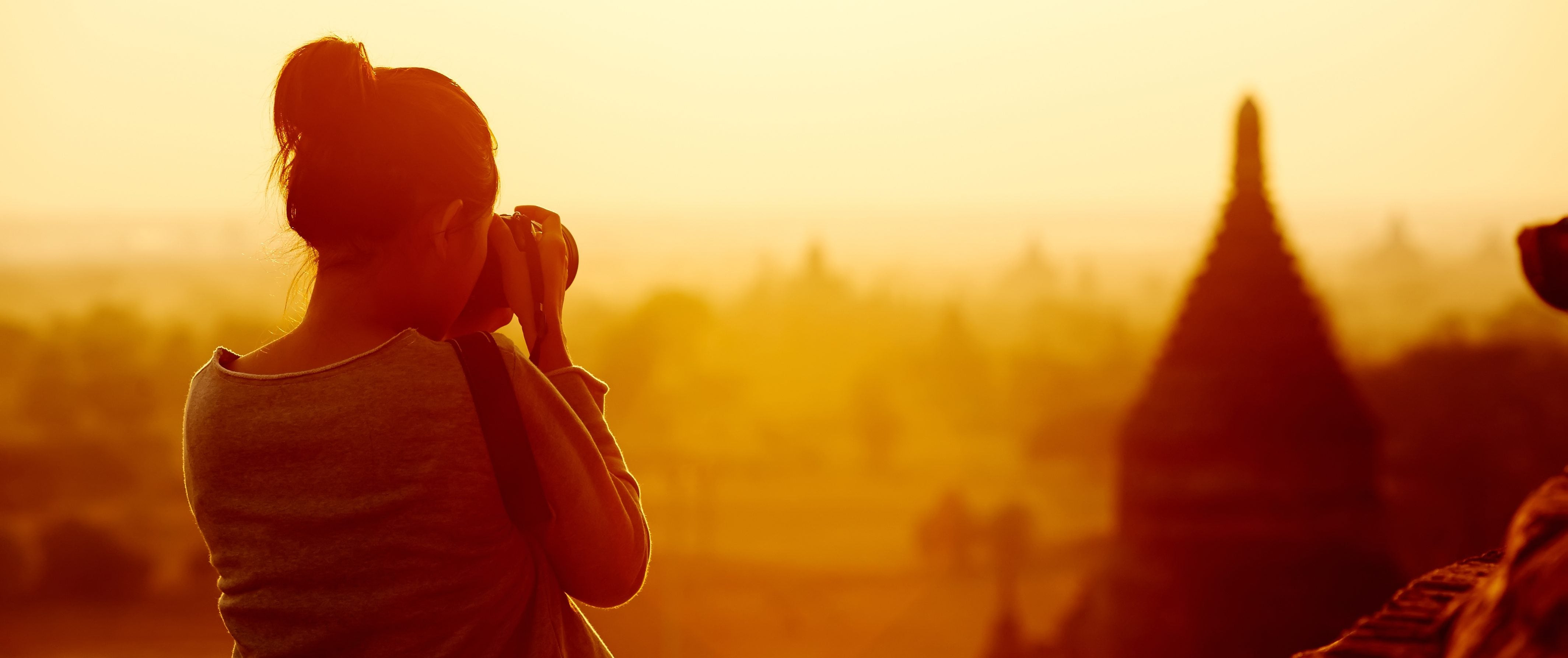 A woman takes pictures of a city