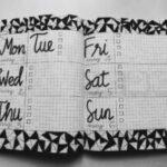 white and black weekly planner on gray surface airbnb discounts