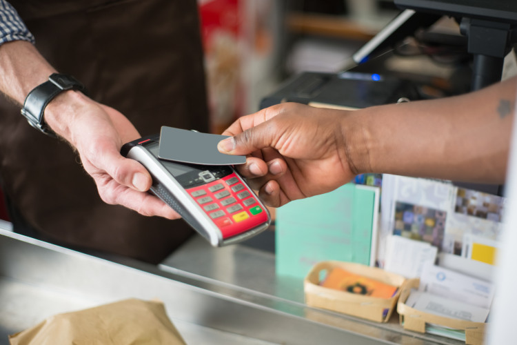 Man scanning his grocery store loyalty card.